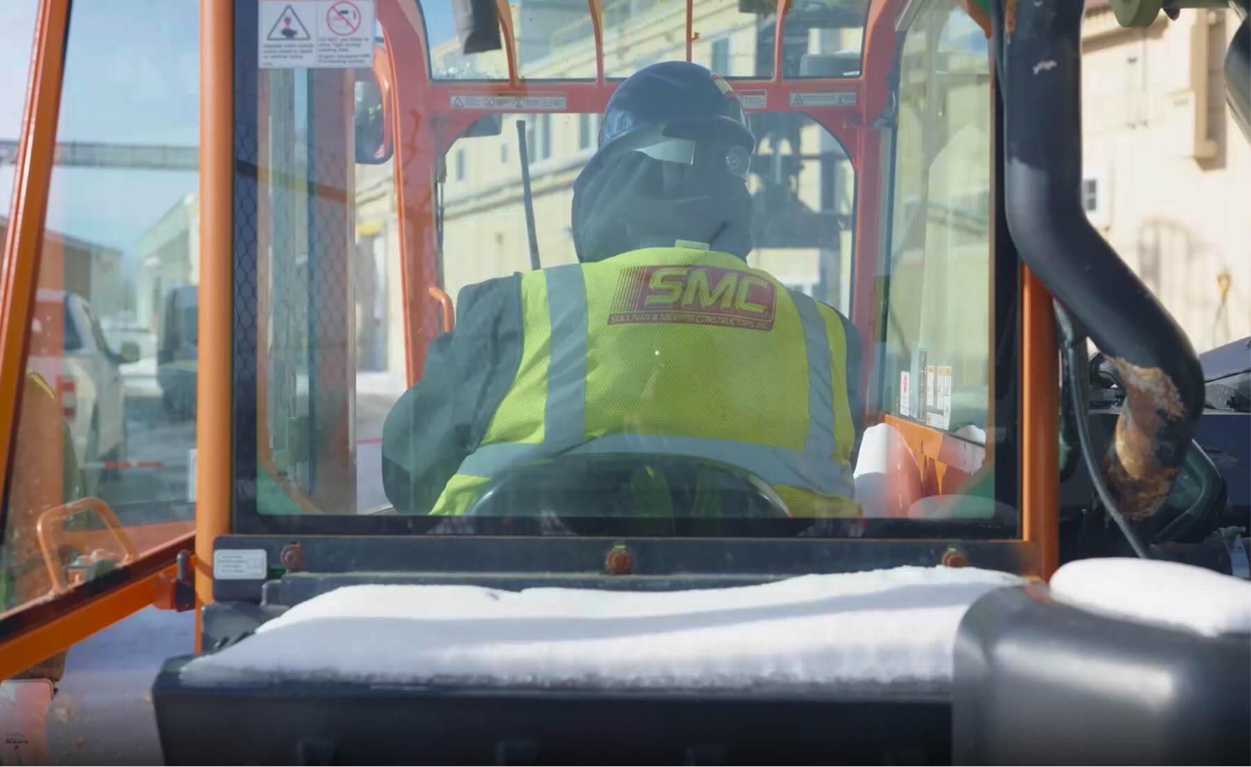 SMC worker with vest and helmet on